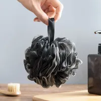 Modern black washing sponge in luxurious design with satin ribbon