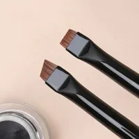 Professional brush on the contours of eyebrows and eyeliner