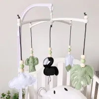 Cute baby hanging rattles above the crib