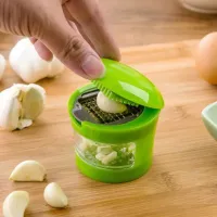 Practical garlic press with jar - green color, helpful kitchen helper