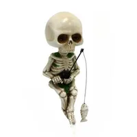 Decoration for a fish tank in the shape of a little scary fisherman skeleton