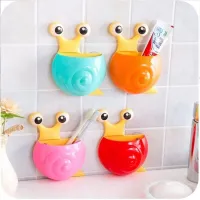 Cheerful toothbrush holder in the shape of a snail