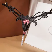 Seksowne stringi z koronką do masażu w kwiaty
