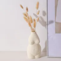 A decorative vase in the shape of a woman's body