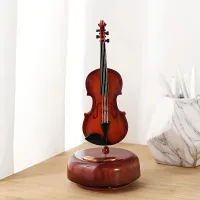 Vintage wooden rotating violin in the shape of music