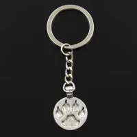 Stylish keychain in round shape with pounded dog foot - silver and bronze color