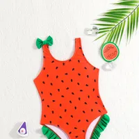 One-piece swimsuits for girls with a motif of watermelon and bows on hangers